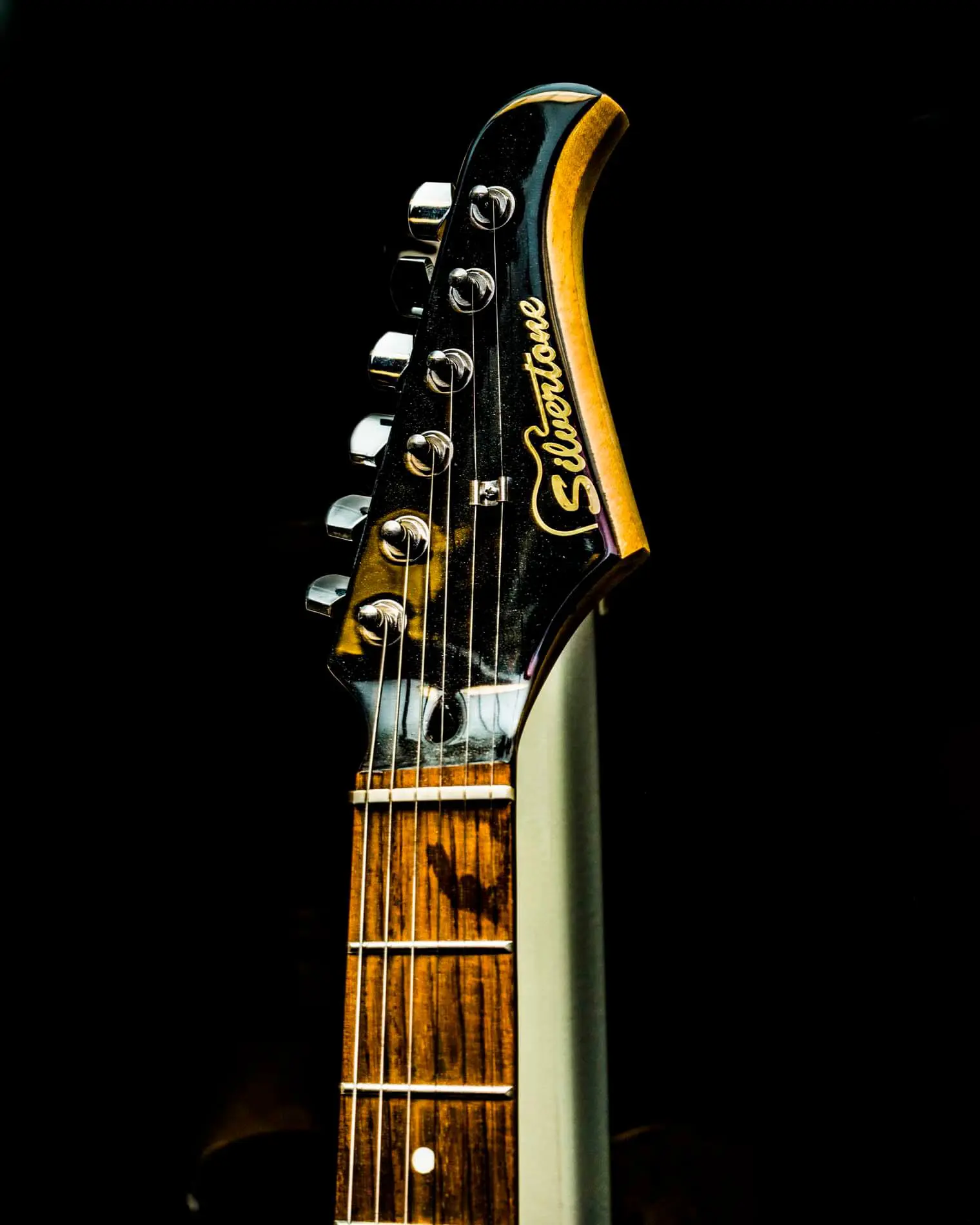 Silvertone guitar shot against a black background