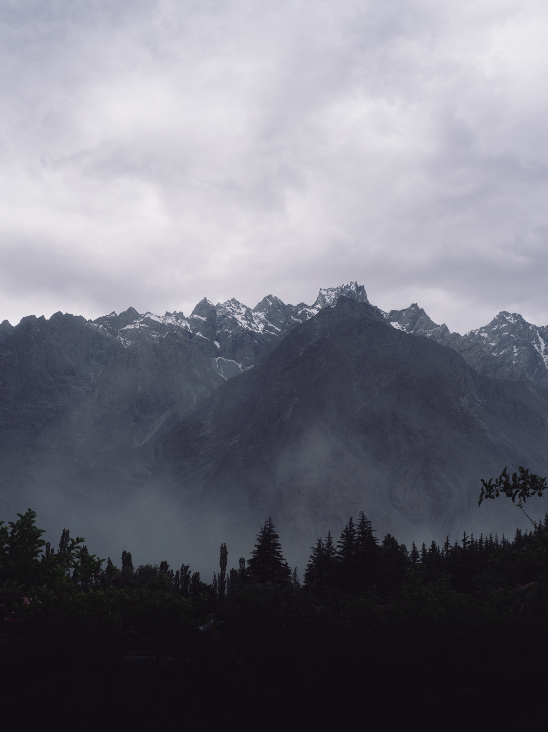 A cloudy day as the sun sets over the Karakoram mountains