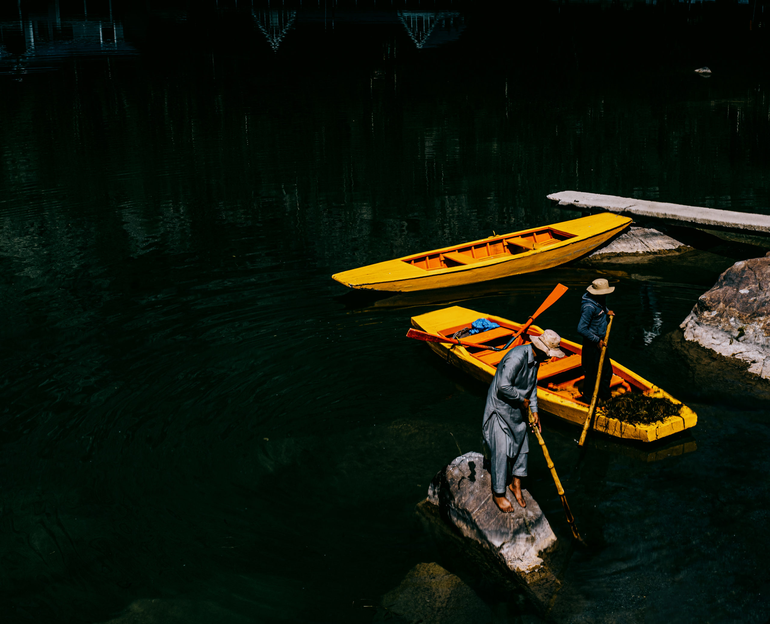 Fisherman cleaning a yellow Kayak