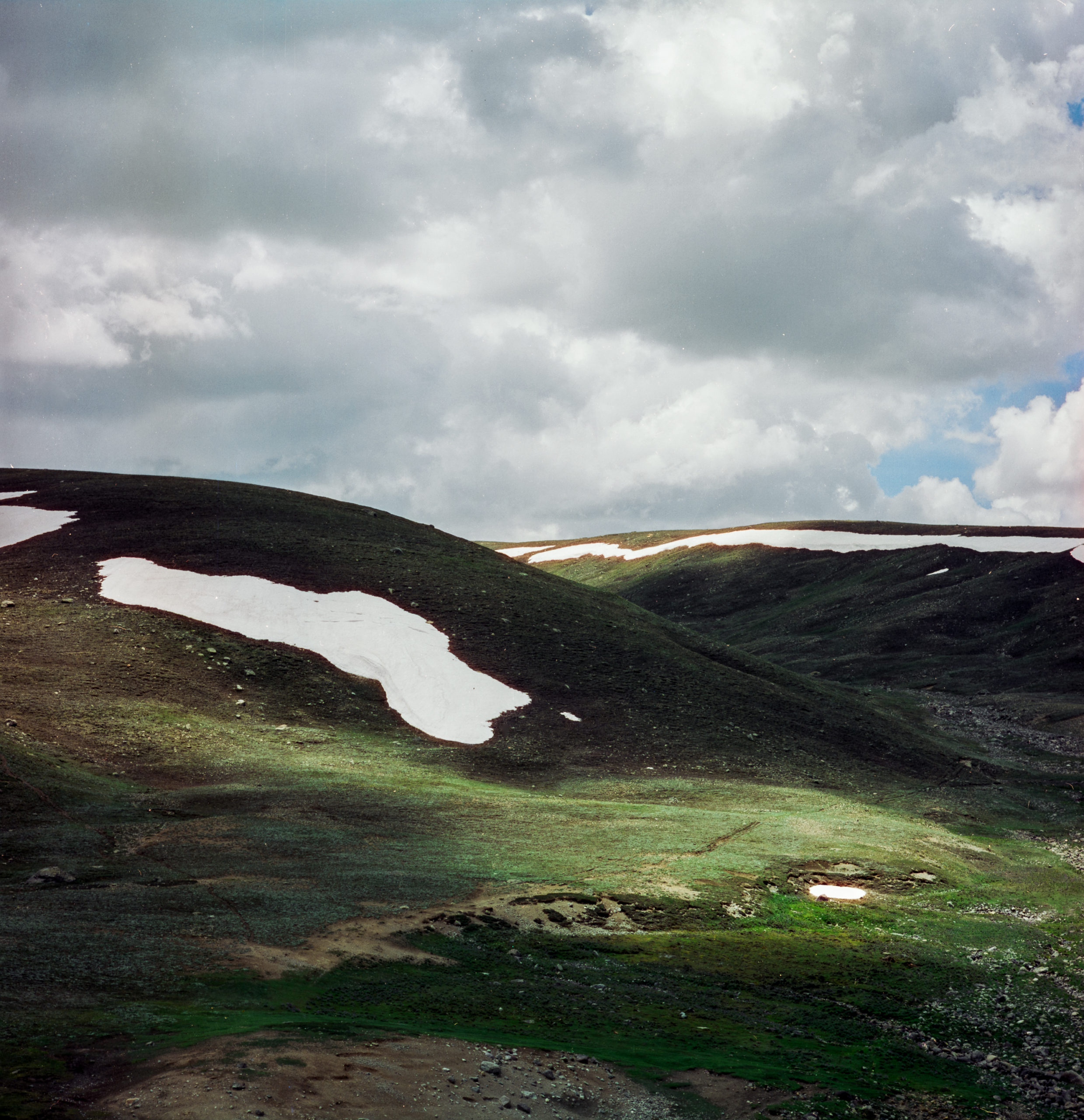 Green hills with dramatic lighting in Deosai National park