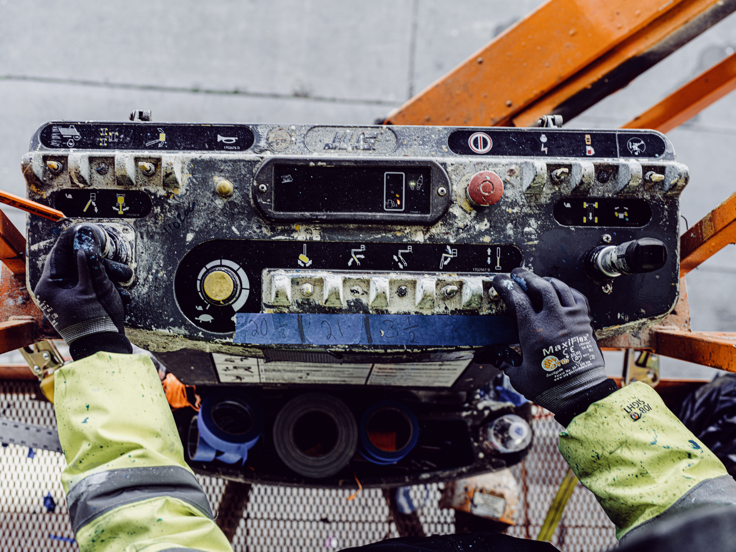 A worker operating a construction lift