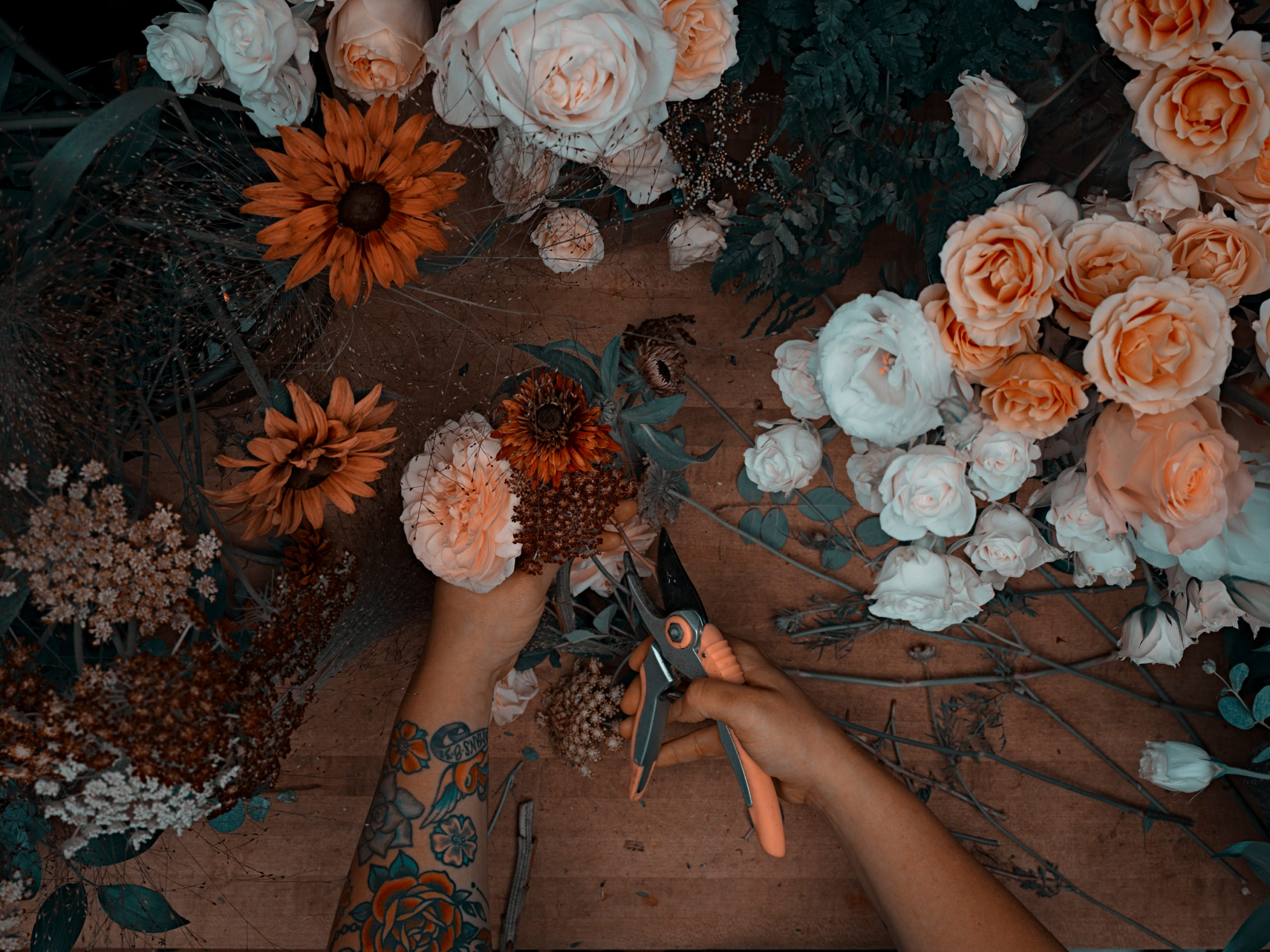 A florist prepares a bouqet for a wedding